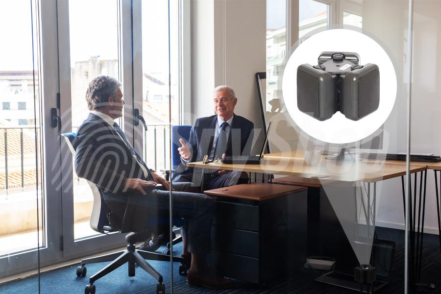 Business meeting in a conference room, two men in suits at a table. In the smaller illustration, a noise generator is visible in the upper right corner.