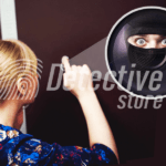 A woman with blonde hair looks through a peephole in a doorway. Zoomed in, we see the terrifying gaze of a masked man looking through the peephole from outside.